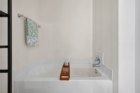 a utility room with fridge and washer