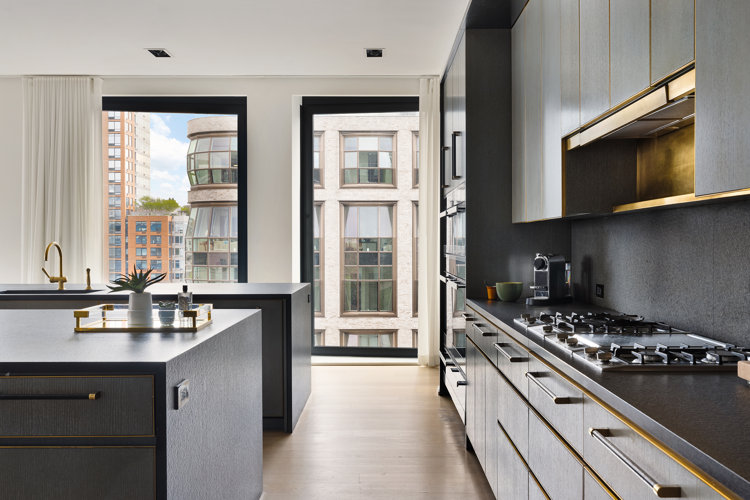 505 West 19th Street, Unit PH1 Manhattan, NY 10011 - Photo 9 of 26 a kitchen with a stove a sink and a microwave