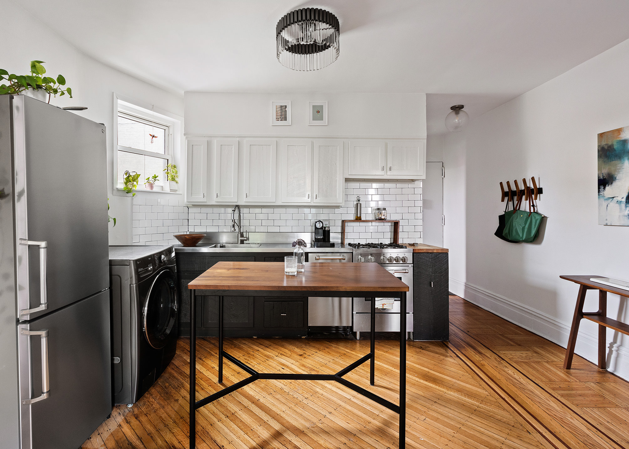 415 9th Street, Unit 53 Brooklyn, NY 11215 - Photo 2 of 5 a kitchen with kitchen island a counter space a sink appliances and cabinets
