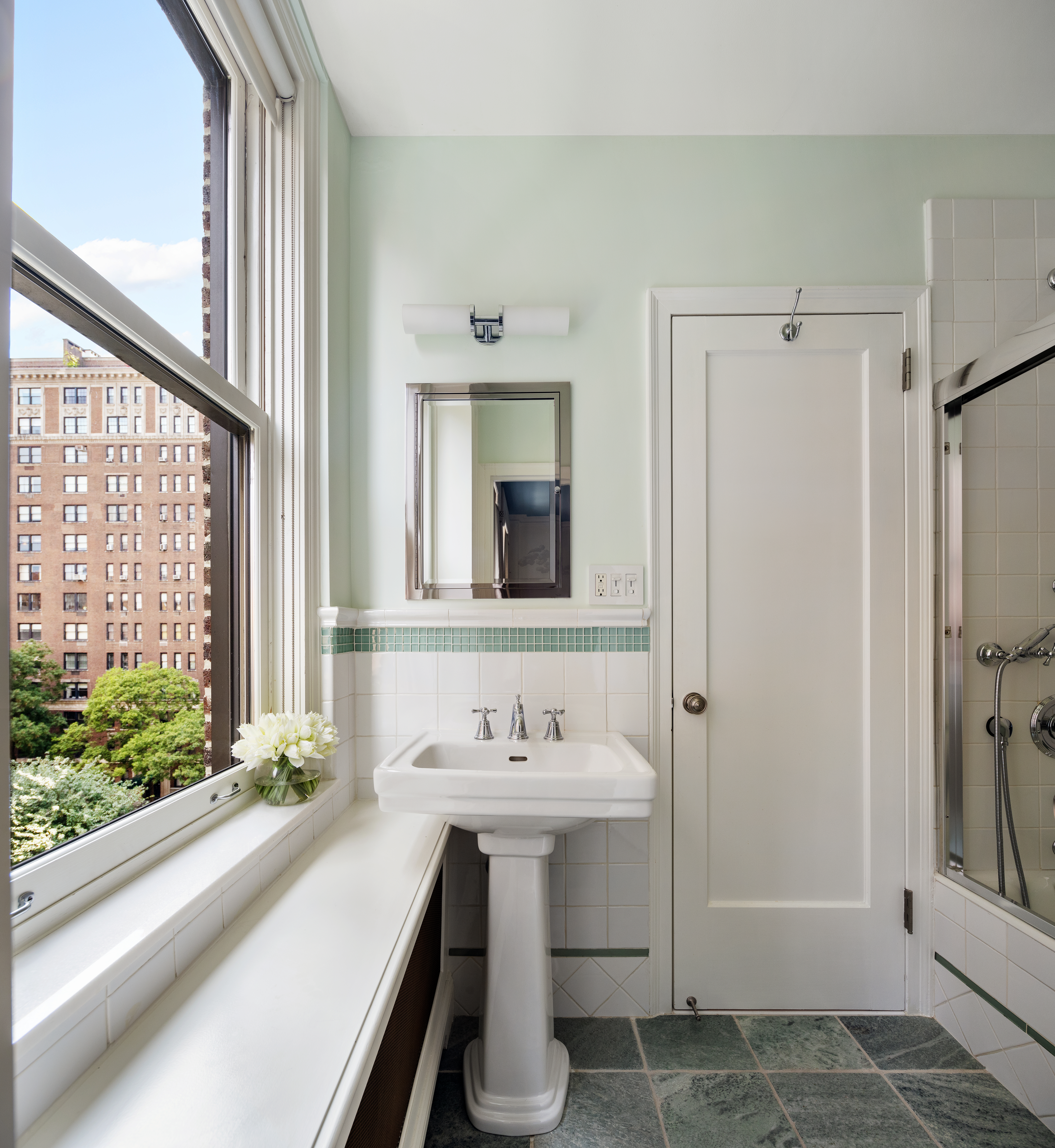 1112 Park Avenue, Unit 6A Manhattan, NY 10128 - Photo 11 of 15 a bathroom with a sink and a mirror