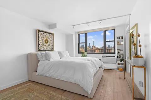 a bedroom with a large bed and a large window