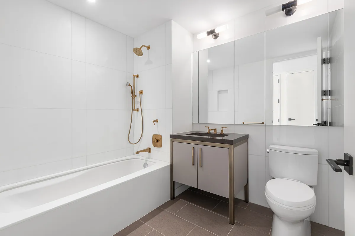 500 West 21st Street, Unit 2G Manhattan, NY 10011 - Photo 11 of 21 a bathroom with a granite countertop sink toilet and shower