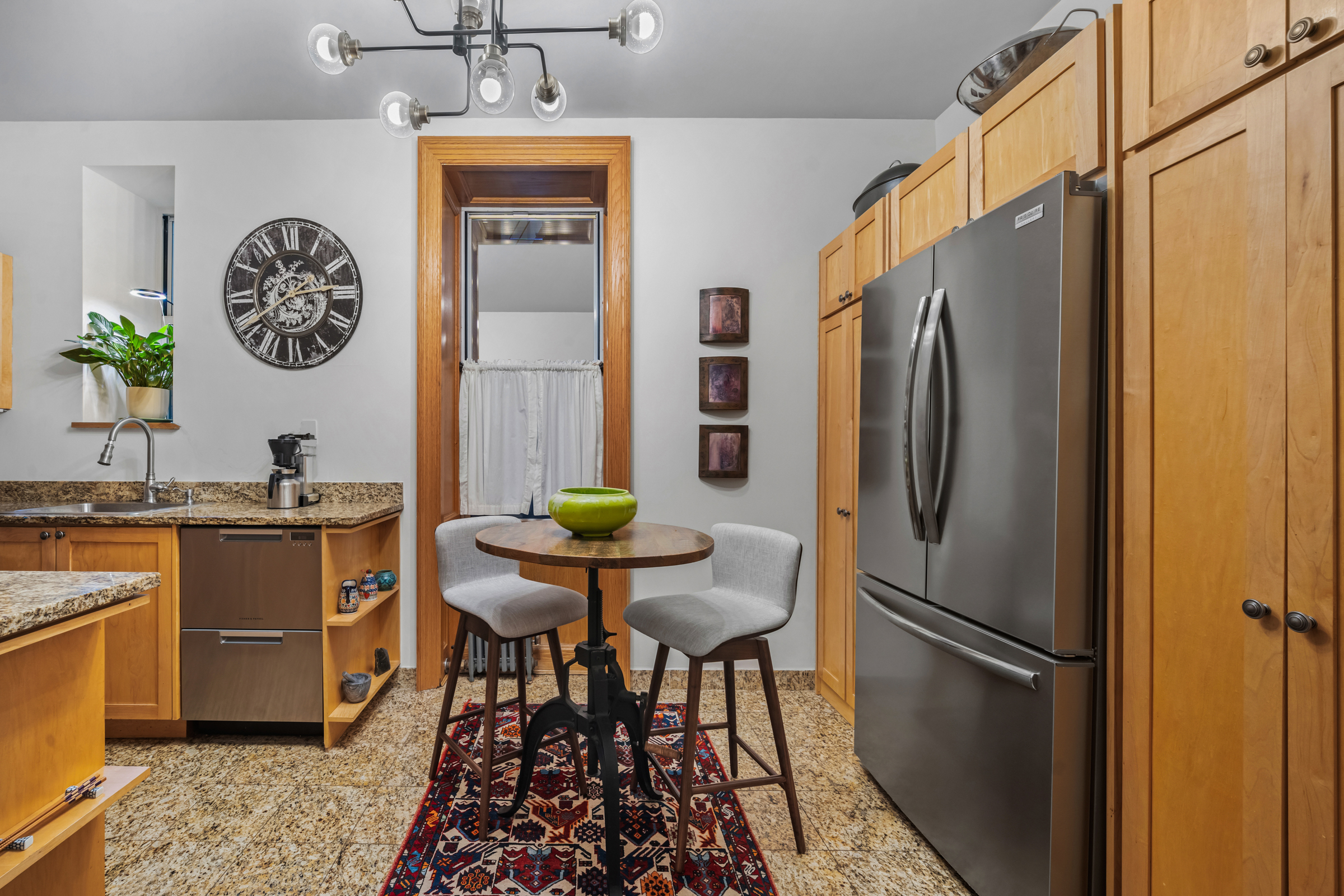 300 West 109th Street, Unit 2JK Manhattan, NY 10025 - Photo 10 of 18 a kitchen with stainless steel appliances a refrigerator a stove a dining table and chairs
