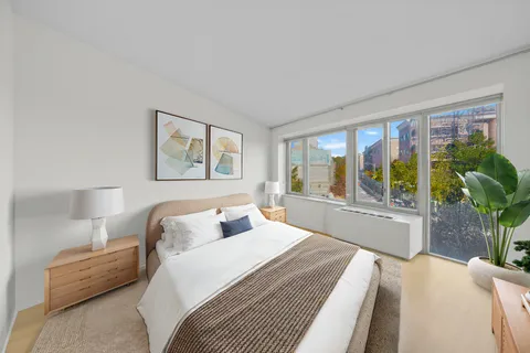 a bedroom with a large bed and a large window