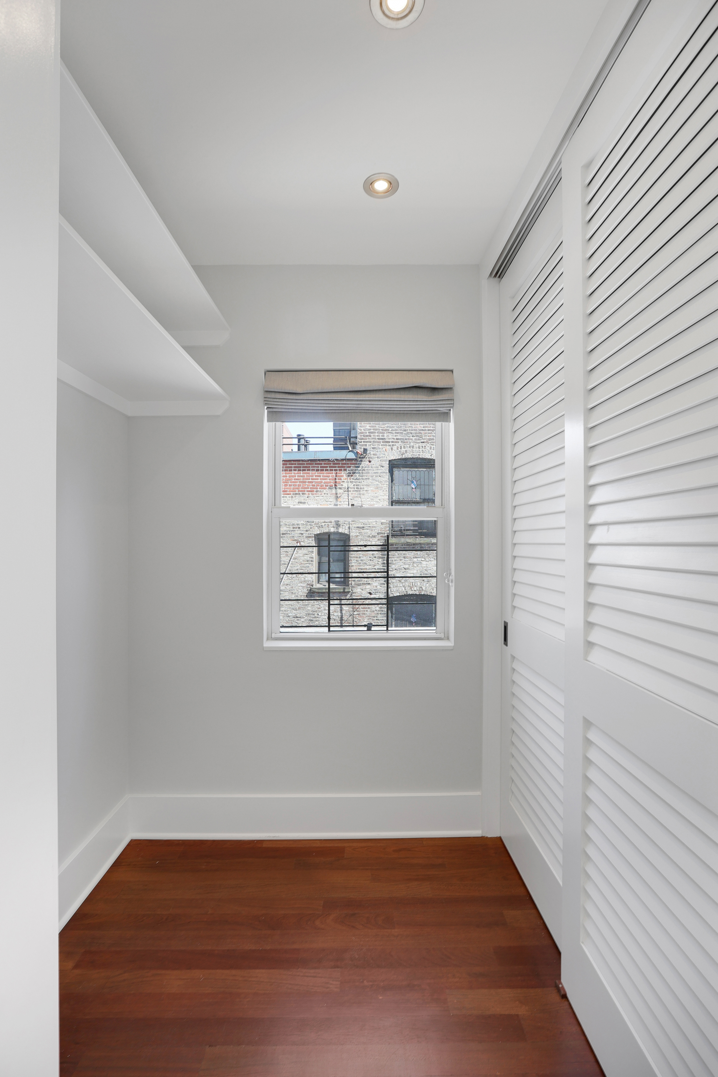 133 East 30th Street, Unit PH5B Manhattan, NY 10016 - Photo 21 of 24 a view of an empty room with wooden floor and a window