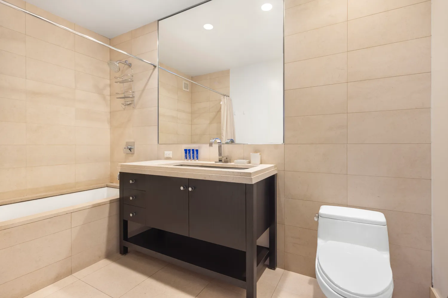 a bathroom with a sink toilet and shower