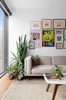 a living room with furniture and a potted plant