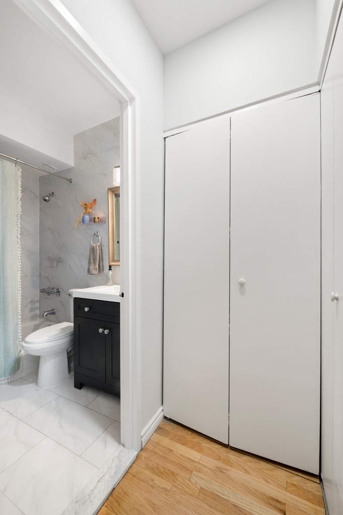 120 Manhattan Avenue, Unit 2A Manhattan, NY 10025 - Photo 6 of 10 a bathroom with a toilet a sink and mirror