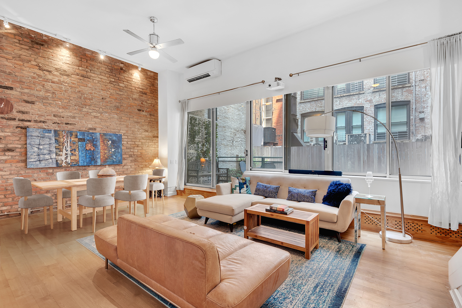 41 East 19th Street, Unit 1B Manhattan, NY 10003 - Photo 2 of 8 a living room with furniture and a large window
