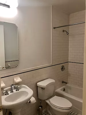 1240 Park Avenue, Unit 3B Manhattan, NY 10128 - Photo 7 of 12 a bathroom with a sink toilet and shower