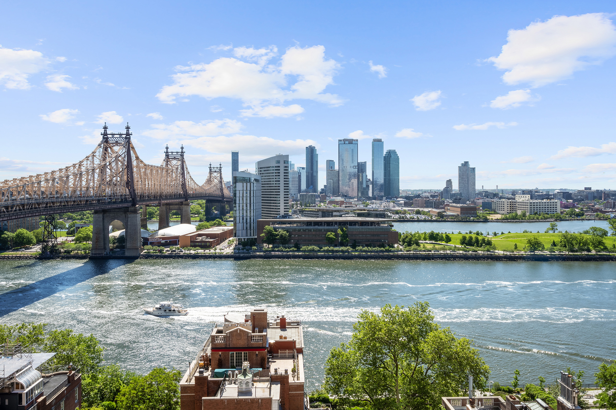 16 Sutton Place, Unit 15C Manhattan, NY 10022 - Photo 2 of 13 a view of a lake with a city