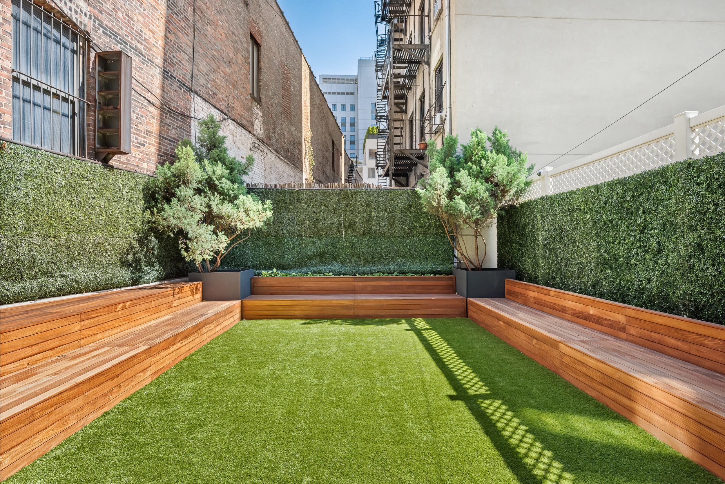 401 East 74th Street, Unit 1A Manhattan, NY 10021 - Photo 8 of 14 a view of building with yard