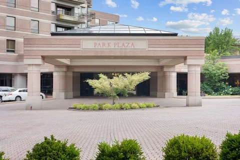 a view of a patio with a dining table and chairs under an umbrella
