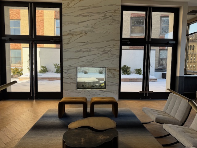 40 Broad Street, Unit 25C Manhattan, NY 10004 - Photo 8 of 10 a living room with furniture and a large window
