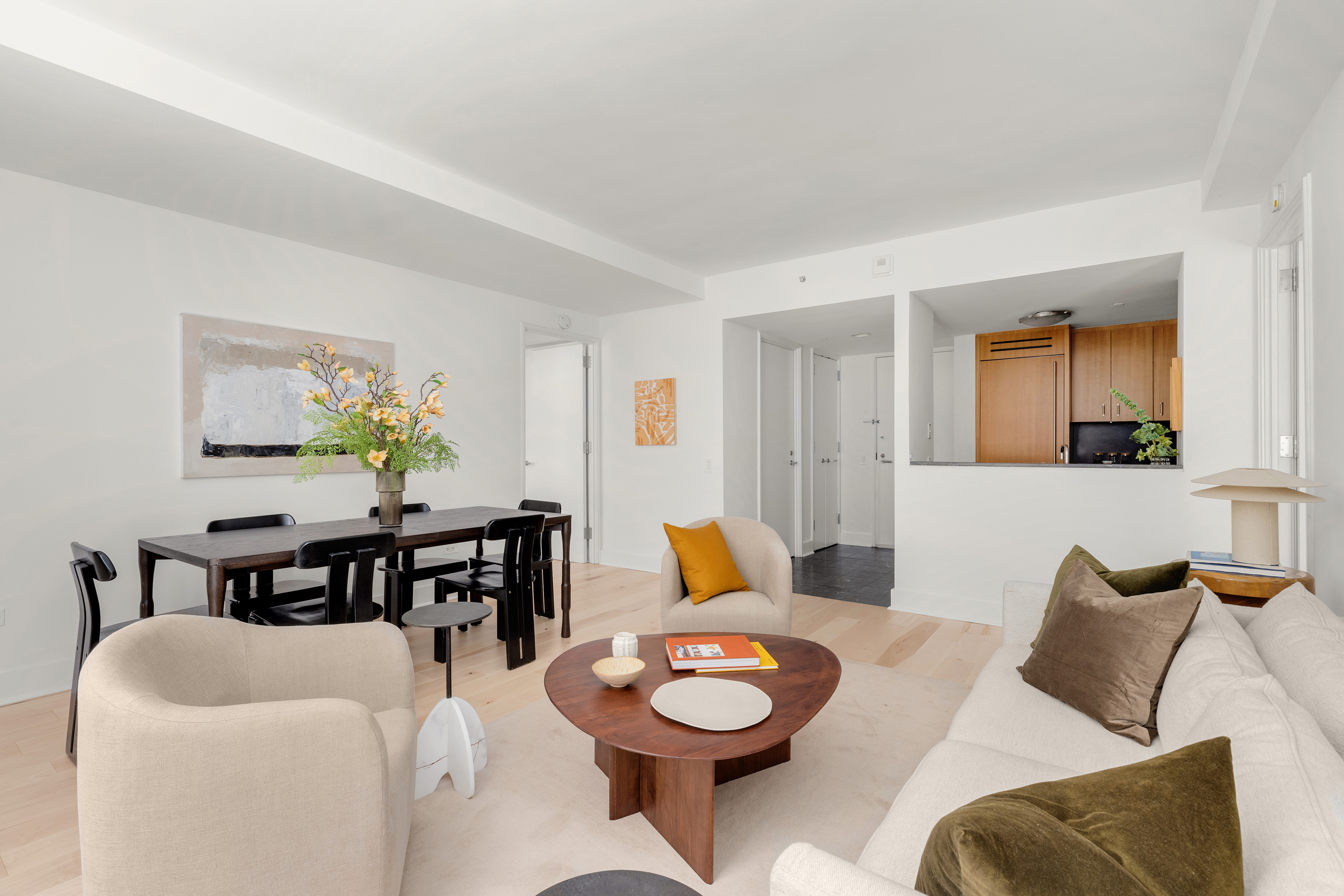 100 West 58th Street, Unit 8C Manhattan, NY 10019 - Photo 3 of 11 a living room with furniture and a wooden floor