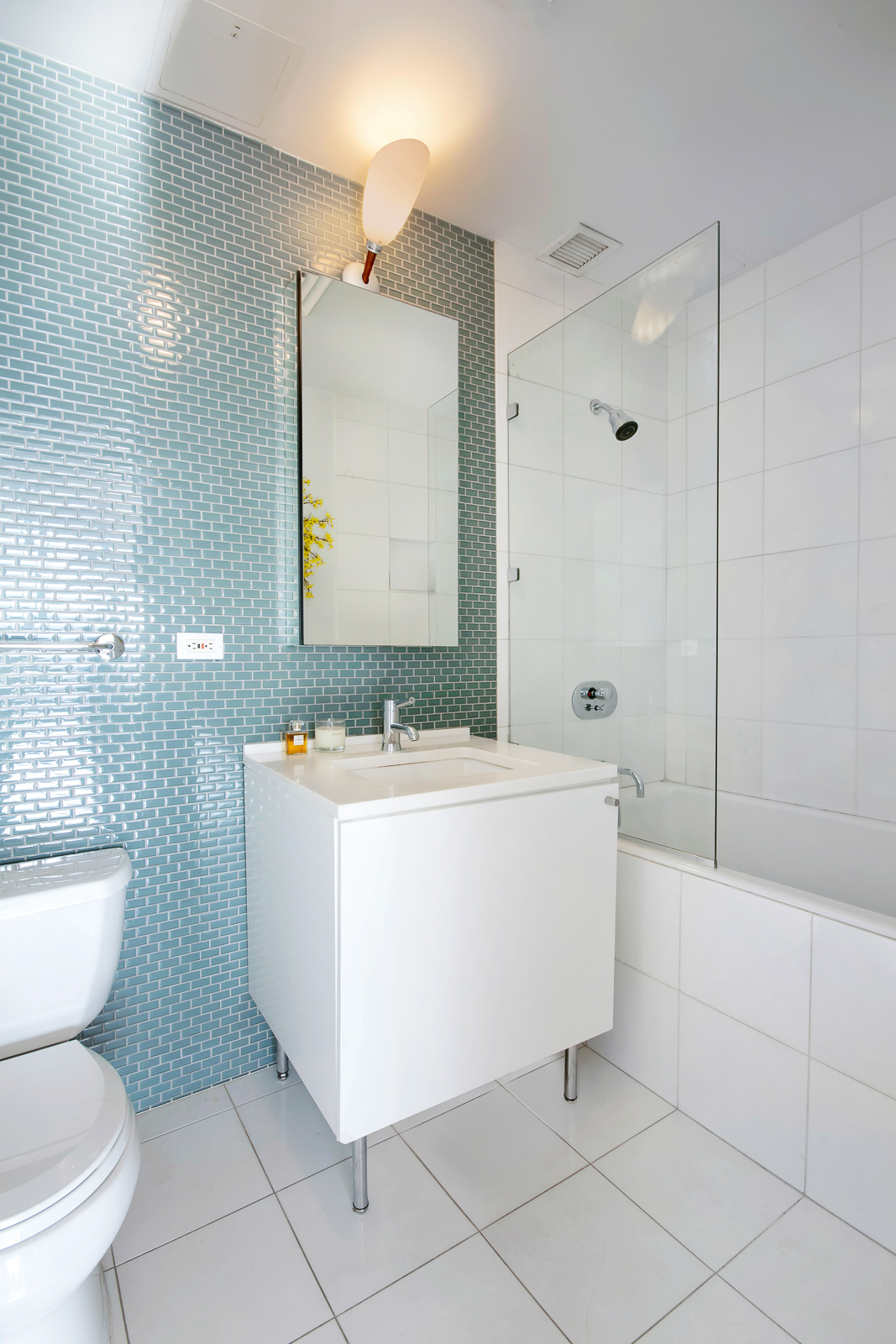 195 Bowery, Unit 7W Manhattan, NY 10002 - Photo 5 of 6 a bathroom with a sink a toilet and bathtub