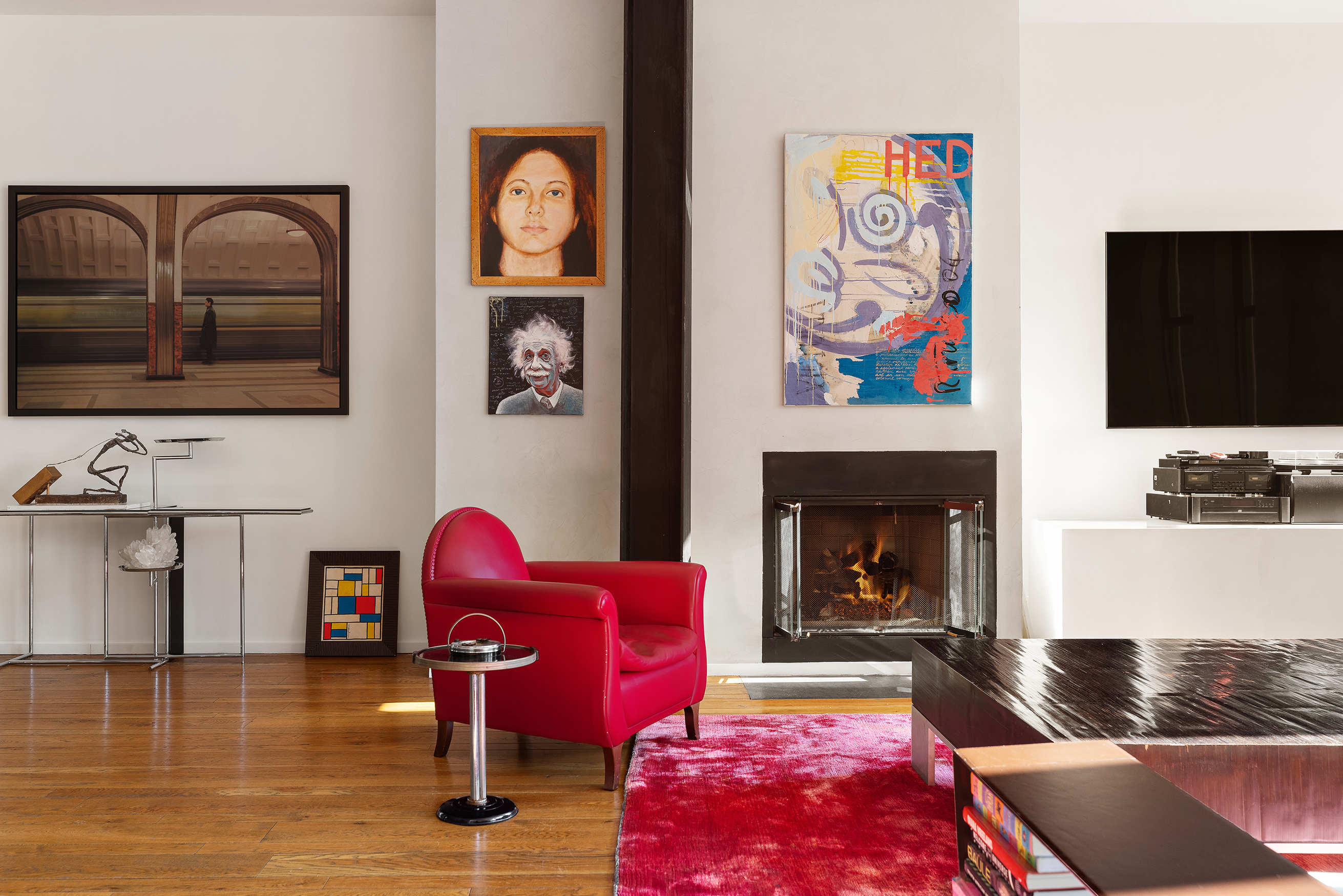 21 Astor Place, Unit 9E Manhattan, NY 10003 - Photo 2 of 10 a living room with furniture fireplace and flat screen tv