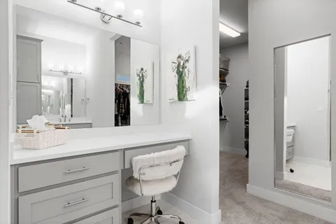 a bathroom with a shower sink and mirror