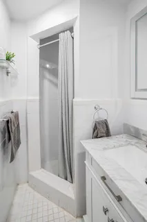 a bathroom with a sink and shower