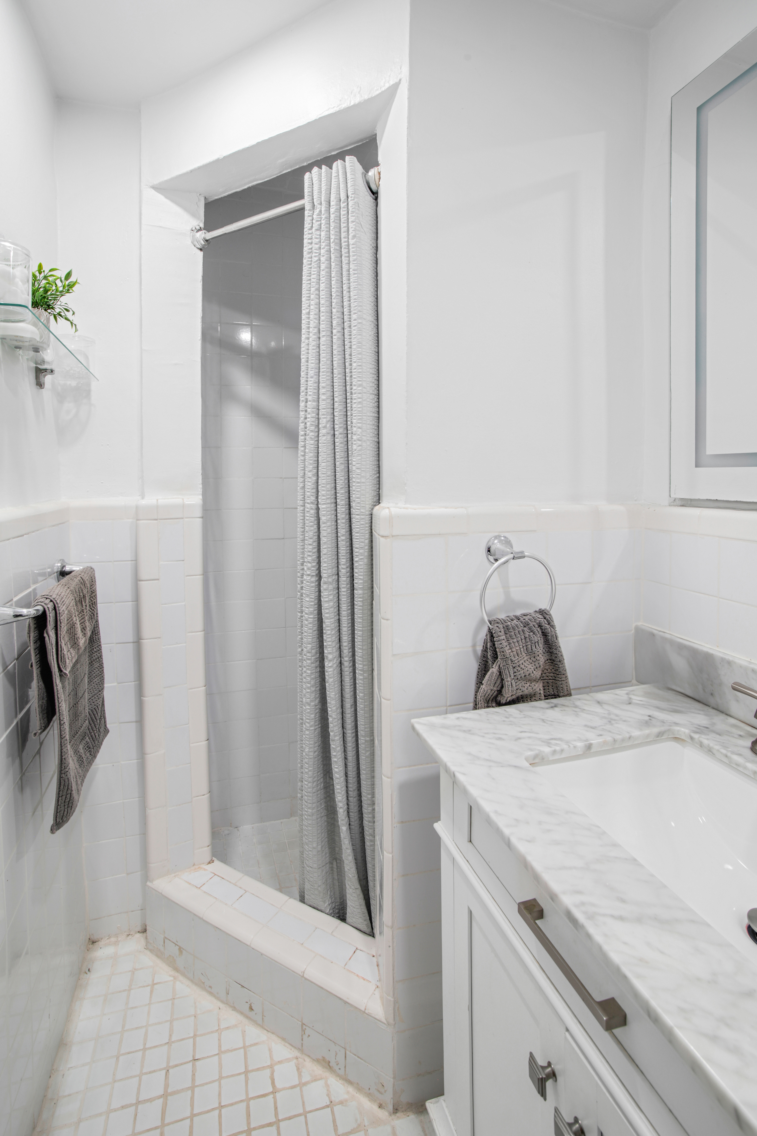 9801 Shore Road, Unit BB Brooklyn, NY 11209 - Photo 5 of 13 a bathroom with a sink and shower