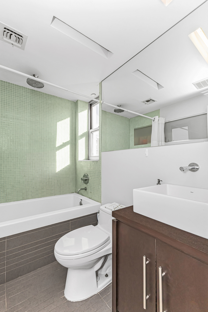 96 Woodpoint Road, Unit 3A Brooklyn, NY 11211 - Photo 10 of 15 a bathroom with a sink a toilet and bathtub