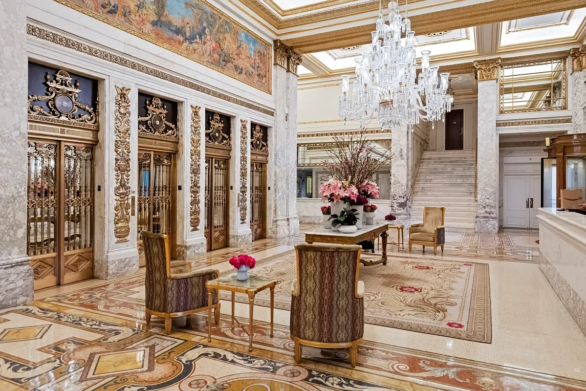 a dining room with wooden floor and chandelier