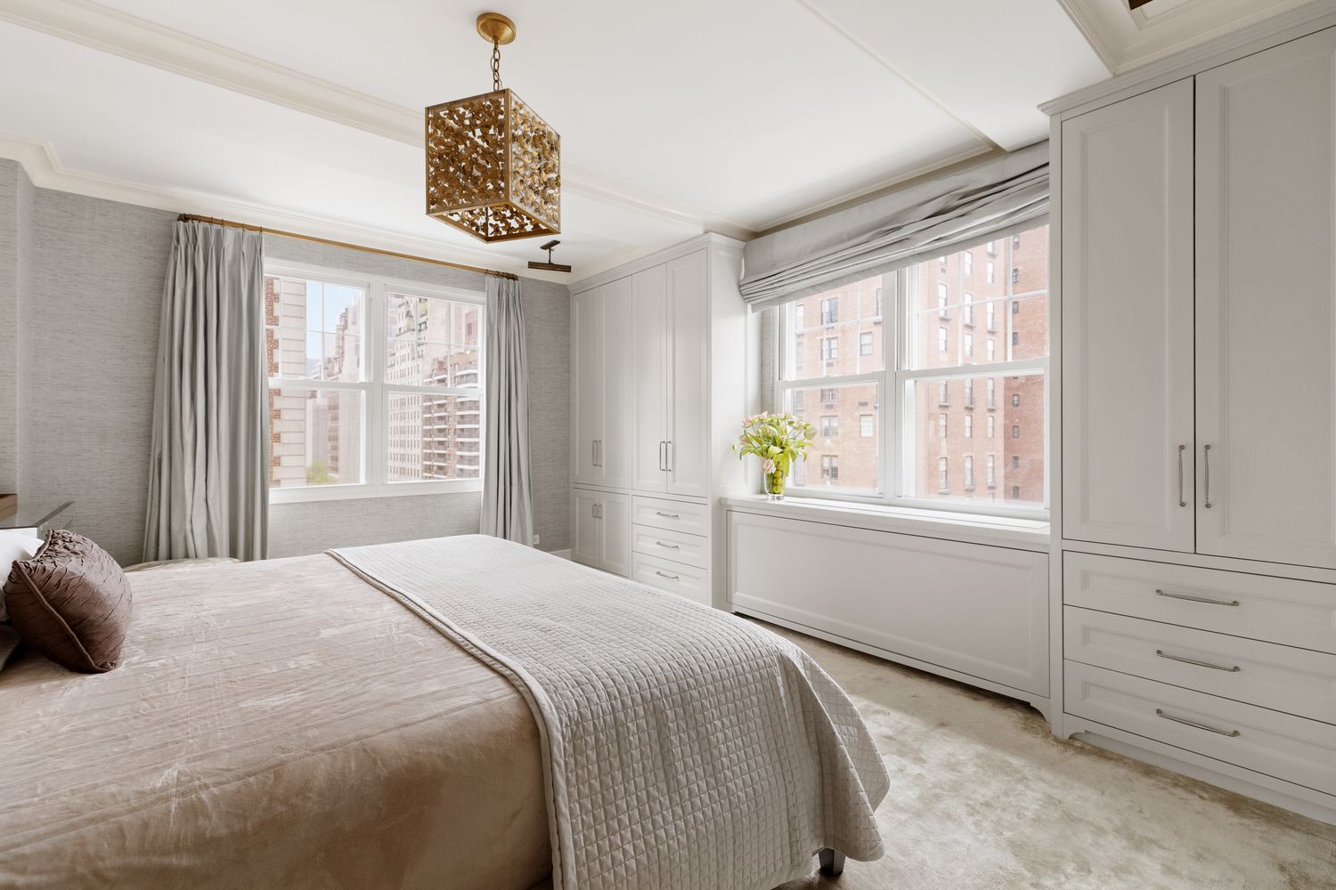 a bedroom with a bed windows and a chandelier
