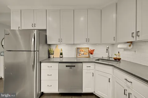 a kitchen with cabinets and stainless steel appliances