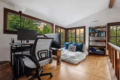 a bathroom with a sink a window and a shower