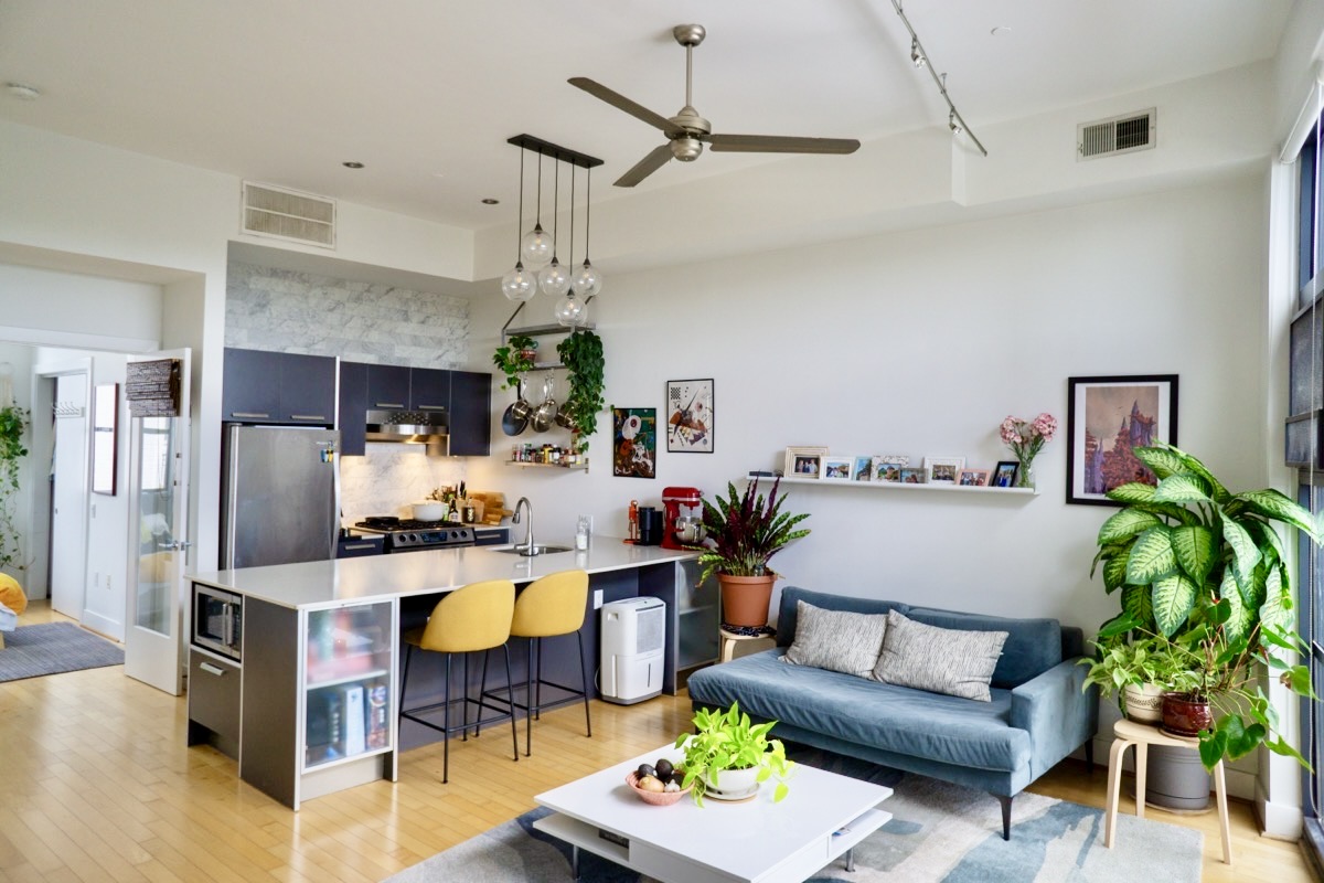 2426 Ontario Road Northwest, Unit 401 Washington, DC 20009 - Photo 2 of 28 a living room with furniture kitchen view and a chandelier