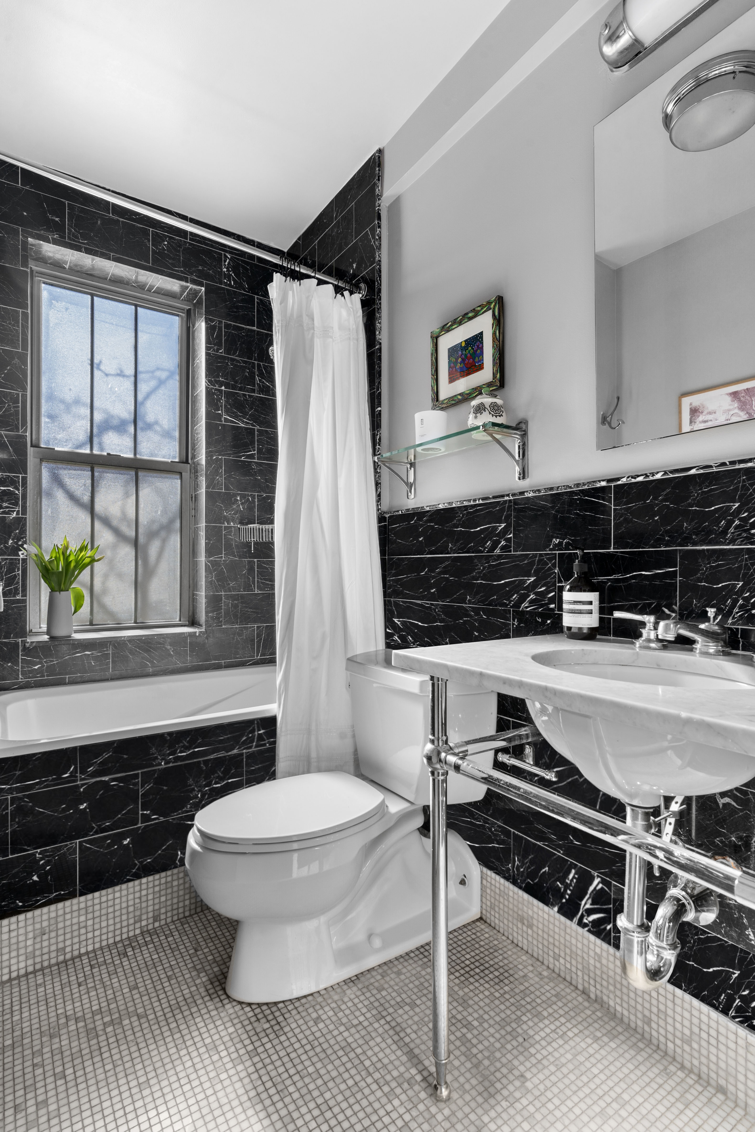 75 Bank Street, Unit 3K Manhattan, NY 10014 - Photo 8 of 11 a bathroom with a toilet a sink and a window