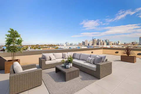 a balcony with furniture and city view