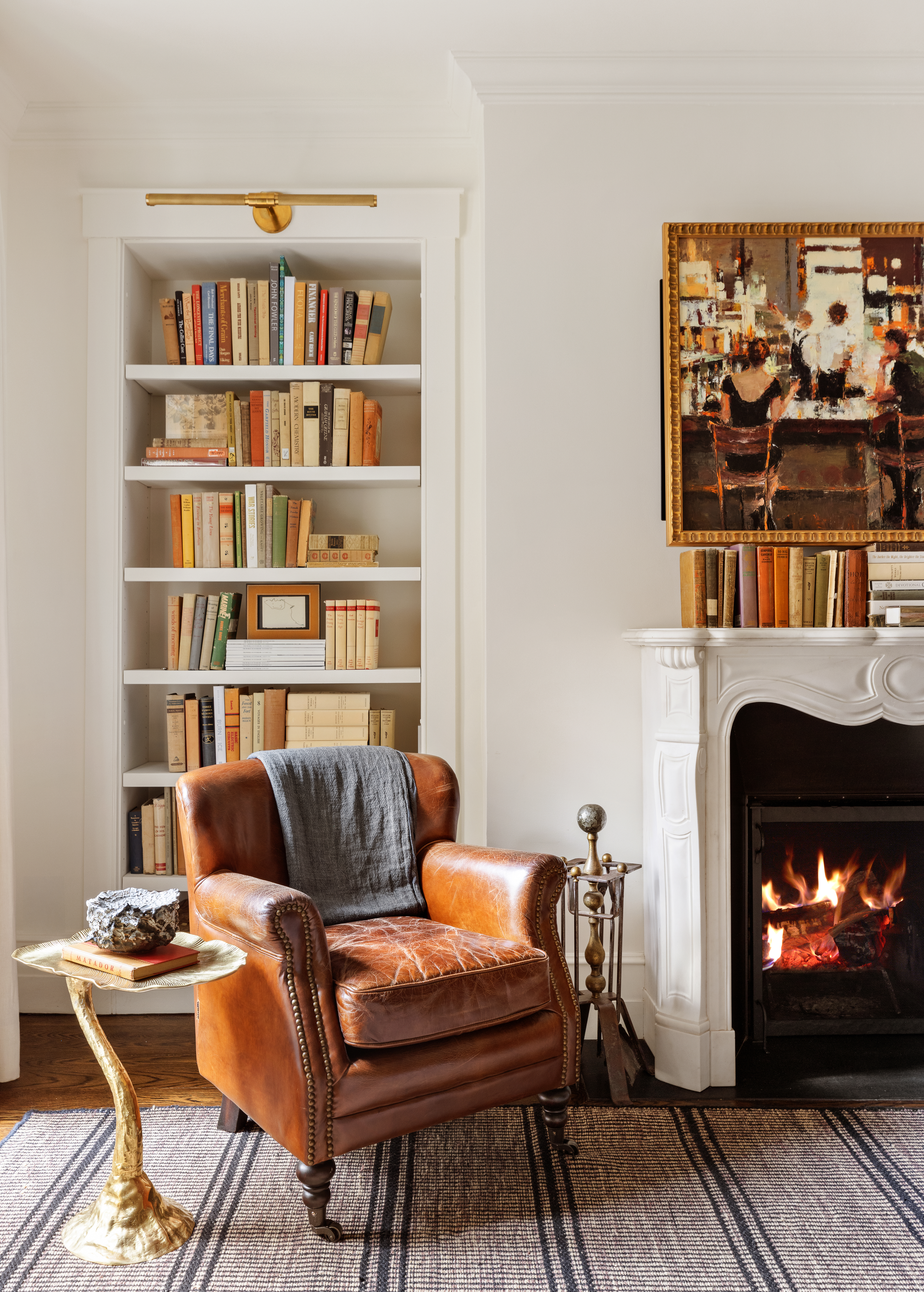 72 Perry Street, Unit GARDEN Manhattan, NY 10014 - Photo 2 of 15 a living room with furniture a bookshelf and a fireplace