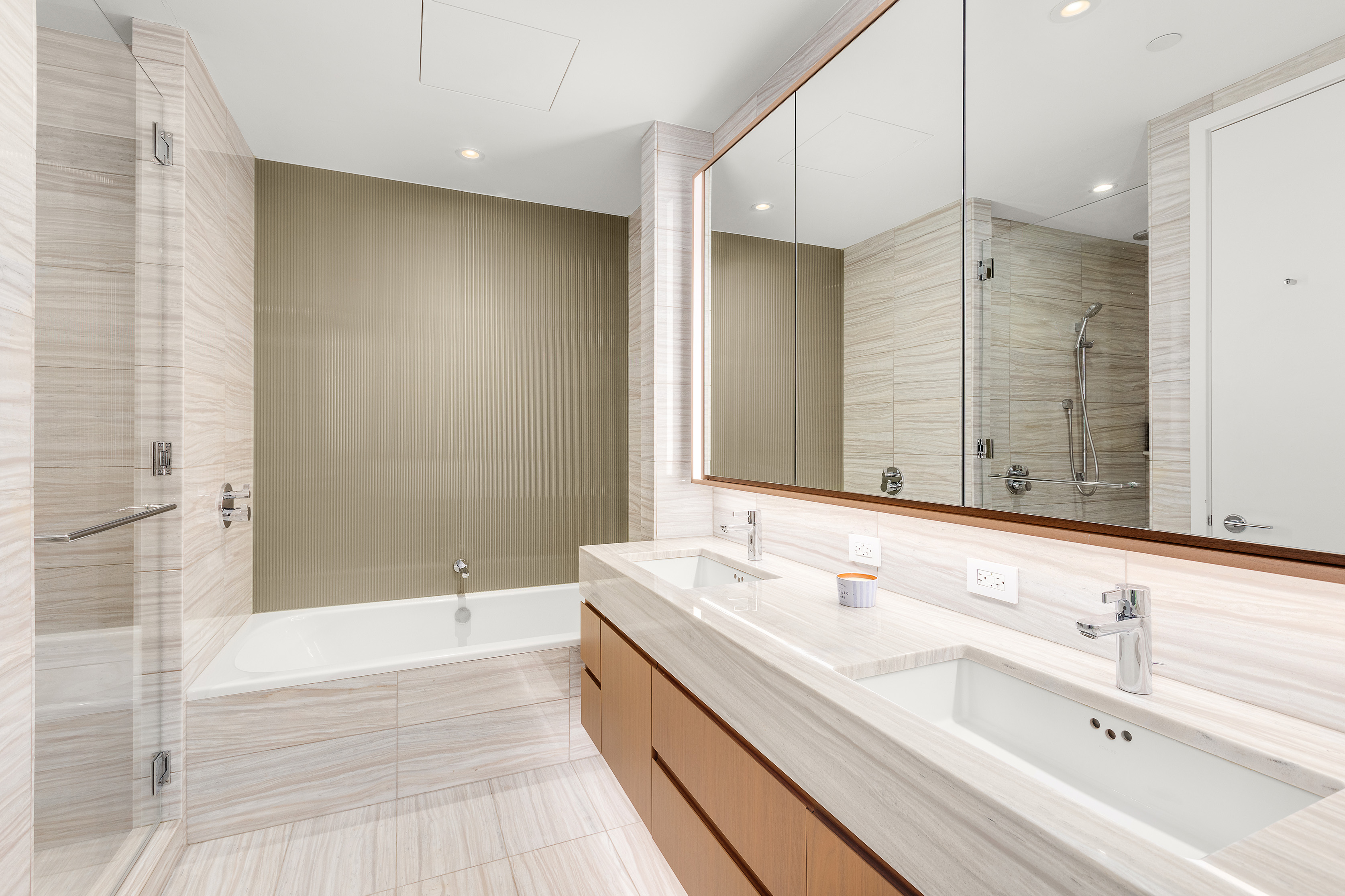 50 West Street, Unit 14B Manhattan, NY 10006 - Photo 8 of 29 a bathroom with a double vanity sink mirror double and bathtub