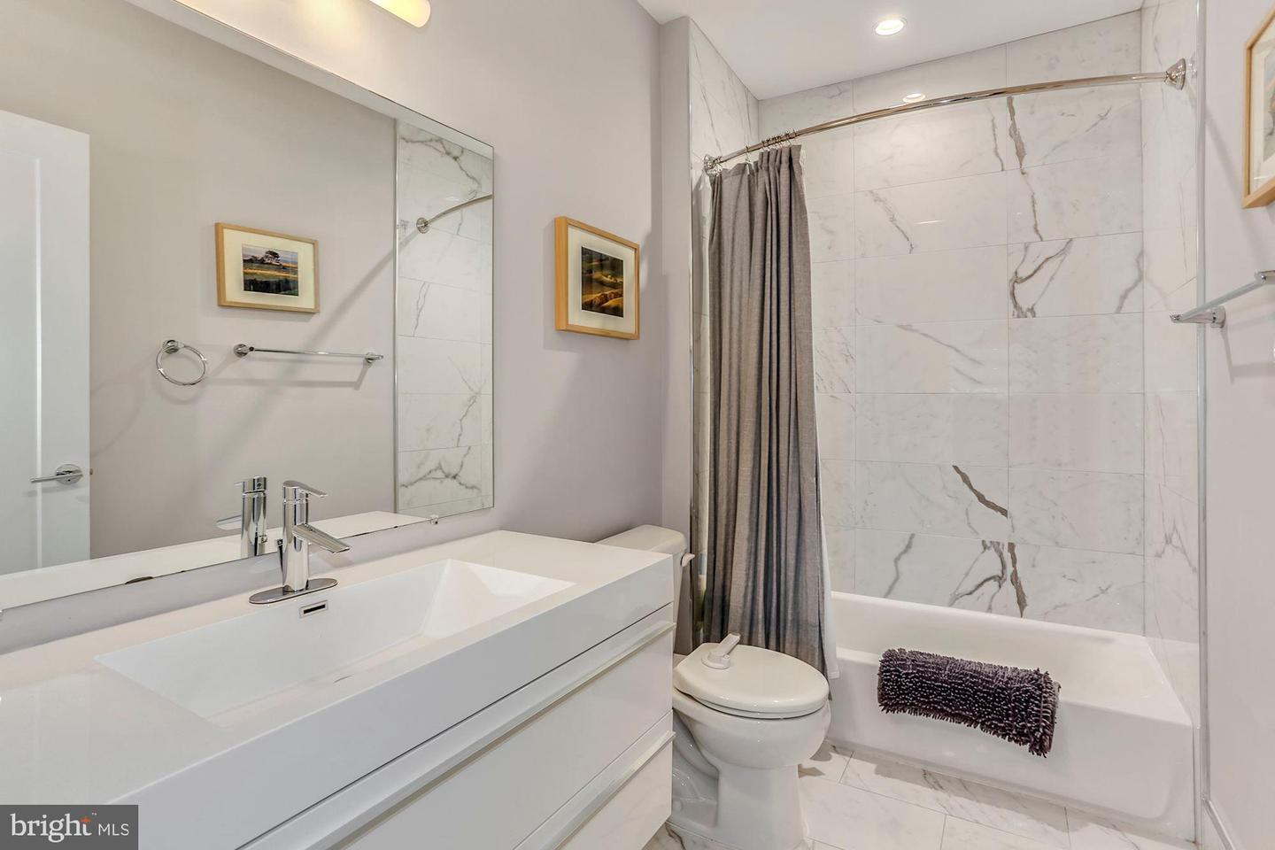 129 Varnum Street Northwest, Unit 6 Washington, DC 20011 - Photo 22 of 25 a bathroom with a sink toilet and shower