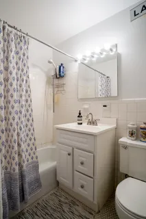 a bathroom with a sink toilet a mirror and shower