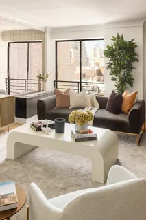 a living room with furniture and large windows