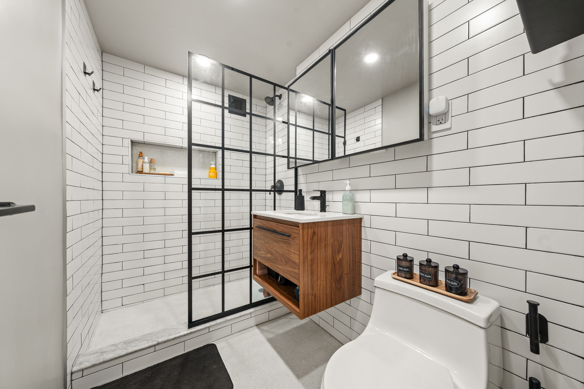 310 Lexington Avenue, Unit 2J Manhattan, NY 10016 - Photo 8 of 11 a bathroom with a sink and mirror