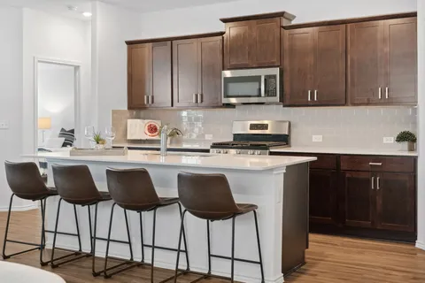 a kitchen with stainless steel appliances granite countertop a sink and cabinets
