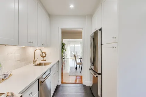 a kitchen with a refrigerator and cabinets
