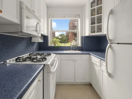 a kitchen with a stove a sink and a refrigerator