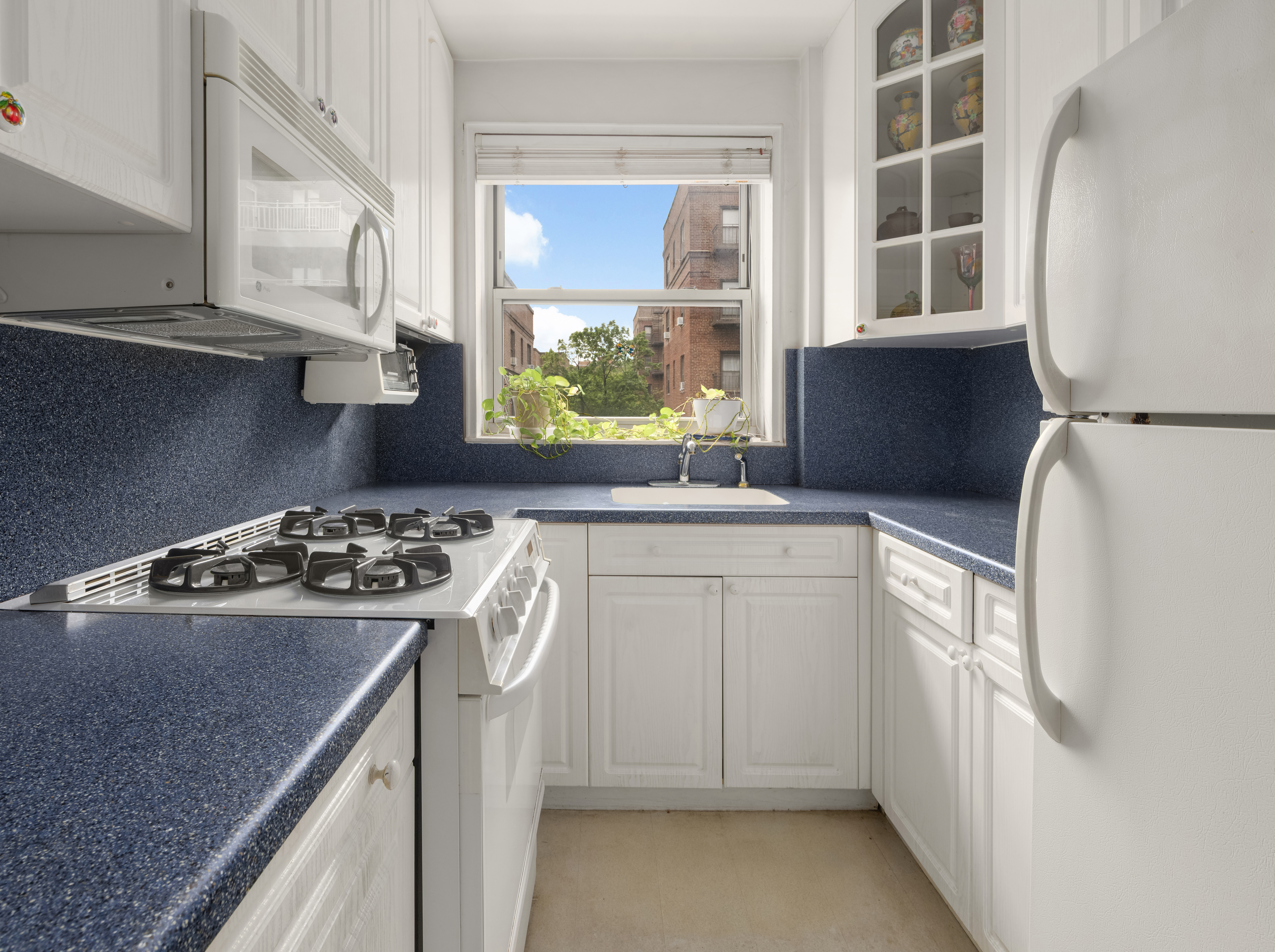 68-61 Yellowstone Boulevard, Unit 618 Queens, NY 11375 - Photo 5 of 13 a kitchen with a stove a sink and a refrigerator