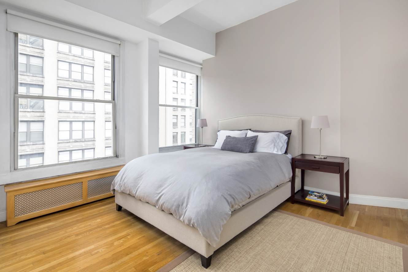 425 Park Avenue South, Unit 9B Manhattan, NY 10016 - Photo 4 of 7 a large bed sitting in a bedroom next to a window