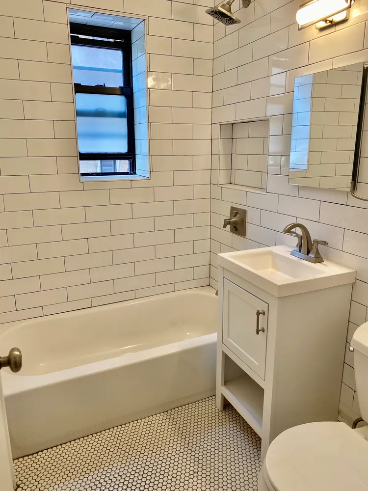 a bathroom with a sink a toilet and bathtub