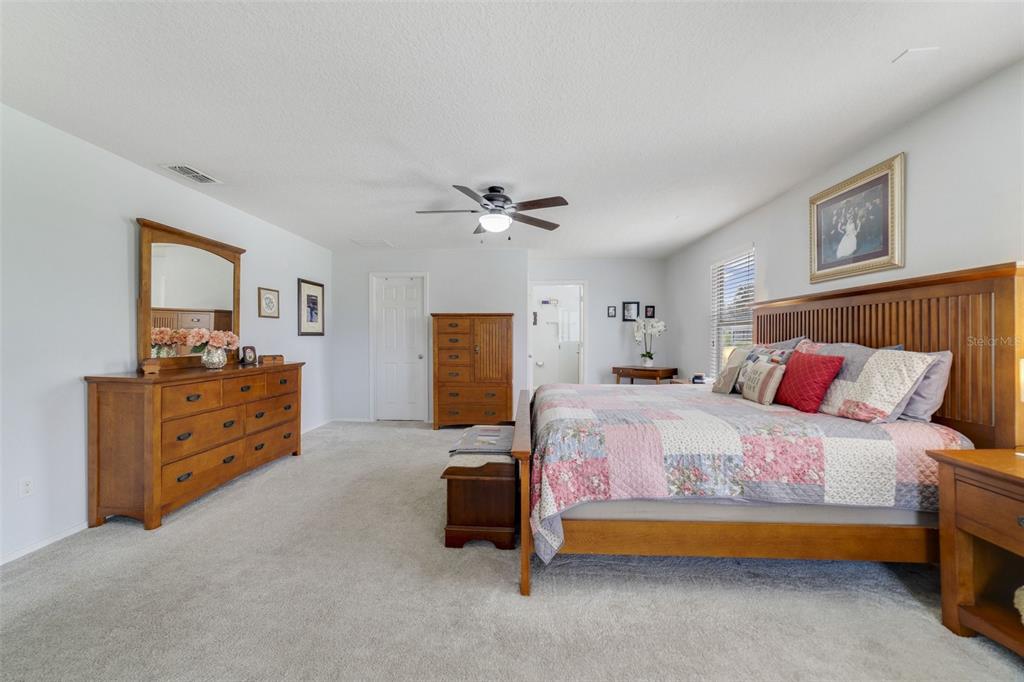 352 Giovani Boulevard Clermont, FL 34715 - Photo 22 of 46 a bedroom with a bed and a dresser in it