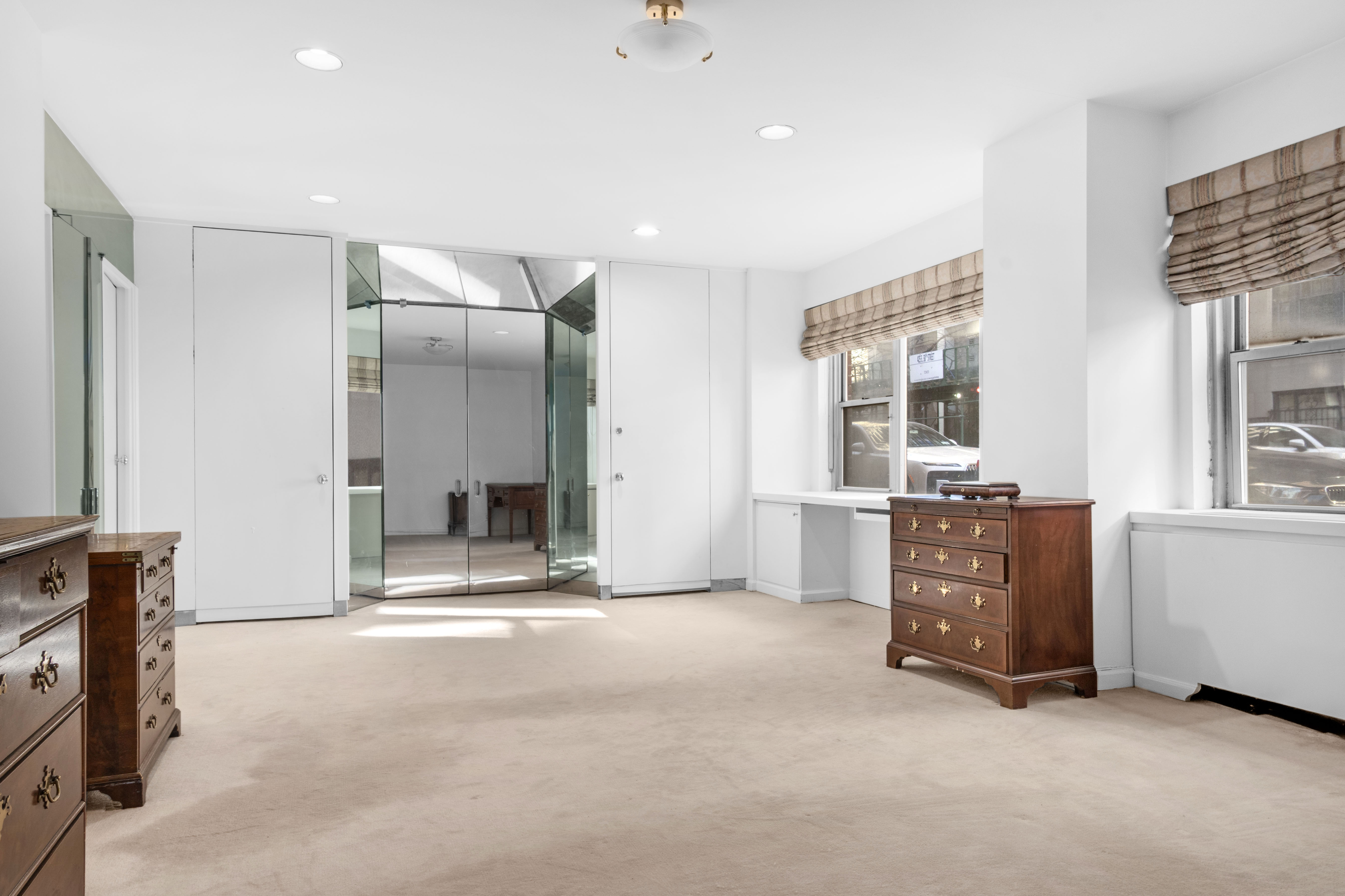 16 Sutton Place, Unit 1A/1B Manhattan, NY 10022 - Photo 8 of 25 a view of an empty room with a fireplace and a window