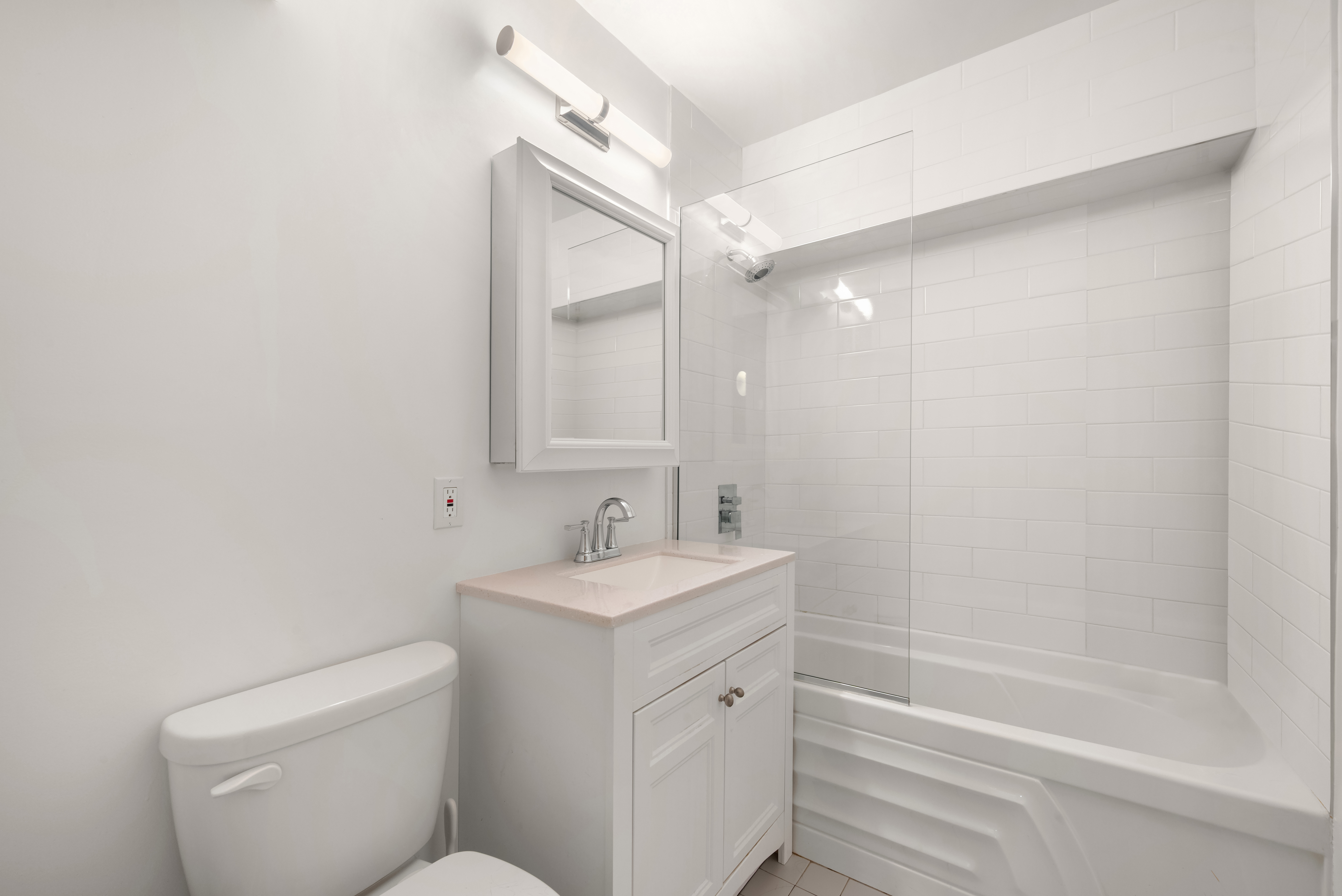 421 Hudson Street, Unit 504 Manhattan, NY 10014 - Photo 11 of 14 a bathroom with a sink a toilet and shower