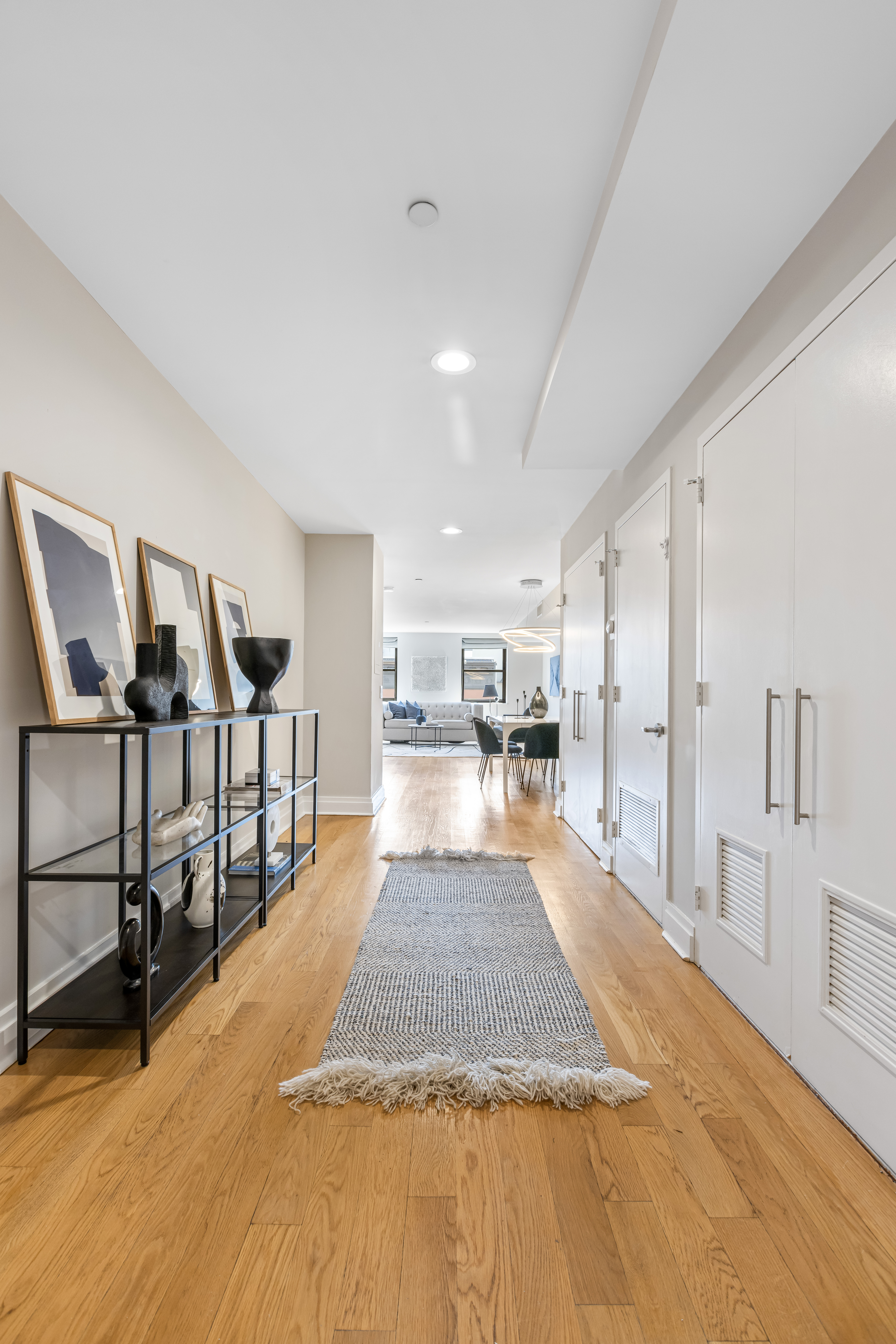 257 West 117th Street, Unit 6A Manhattan, NY 10026 - Photo 13 of 16 a large white kitchen with wooden floor and glass windows