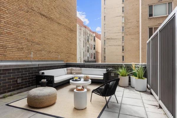 a couple of table and chairs in the balcony