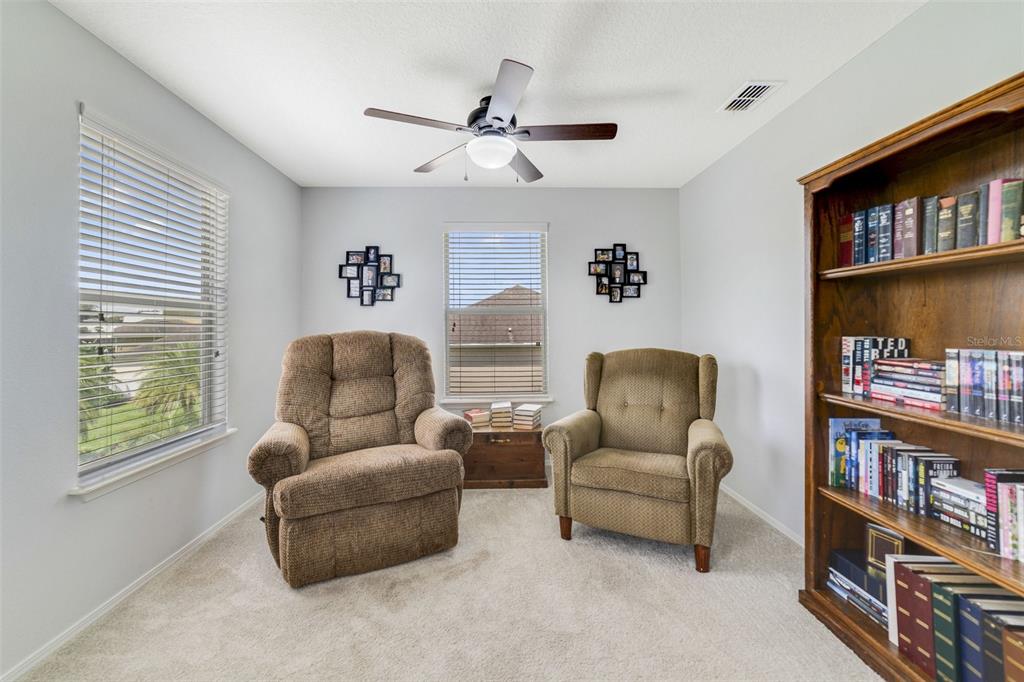 352 Giovani Boulevard Clermont, FL 34715 - Photo 24 of 46 a living room with furniture and book shelf